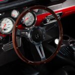14-inch wood grain steering wheel in the 1967 Ford Mustang Fastback 501 Pro-Touring, complementing the restored black vinyl interior with a period-correct classic styling cue