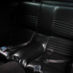Rear fold-down seats in the 1967 Ford Mustang Fastback 501 Pro-Touring, a practical fastback feature finished in matching black vinyl as part of the complete interior restoration