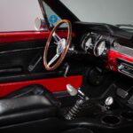 Full interior overview of the 1967 Ford Mustang Fastback 501 Pro-Touring showing the fully restored black vinyl upholstery, Hurst V-Matic2 T-shifter, custom JME Autometer dash gauges, and 14-inch wood grain steering wheel