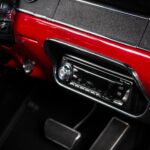 JVC AM/FM/CD radio head unit in the dashboard of the 1967 Ford Mustang Fastback 501 Pro-Touring, paired with kick panel speakers for modern audio in a classic interior setting