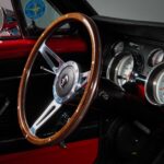 14-inch wood grain steering wheel in the 1967 Ford Mustang Fastback 501 Pro-Touring, complementing the restored black vinyl interior with a period-correct classic styling cue