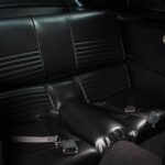 Rear fold-down seats in the 1967 Ford Mustang Fastback 501 Pro-Touring, a practical fastback feature finished in matching black vinyl as part of the complete interior restoration