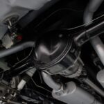 Currie 9-inch Ford rear end with 3.70 gears and posi-traction under the 1967 Ford Mustang Fastback 501 Pro-Touring, paired with traction bars and rear air shocks for optimal performance