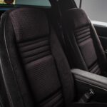 Passenger seat of the black 1978 Pontiac Trans Am WS6 in the fully rebuilt black vinyl interior, matching the driver's seat as part of the complete interior restoration